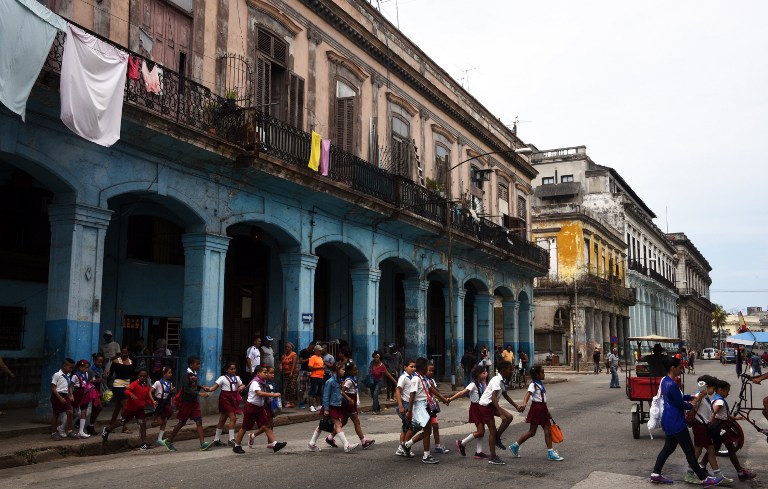 Schoolchildren cross a street in Havana on March 23, 2016. Credit: Rodrigo Arangua—AFP
