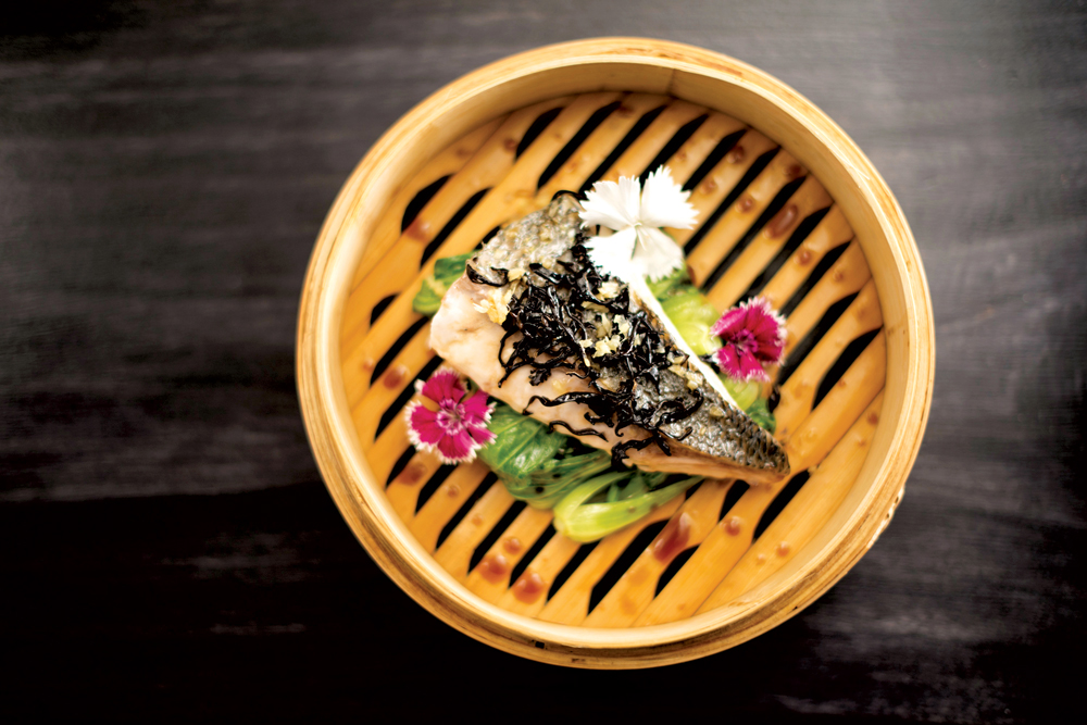 A dish served on a bamboo steamer, just one of Yam'Tcha's Asian influences