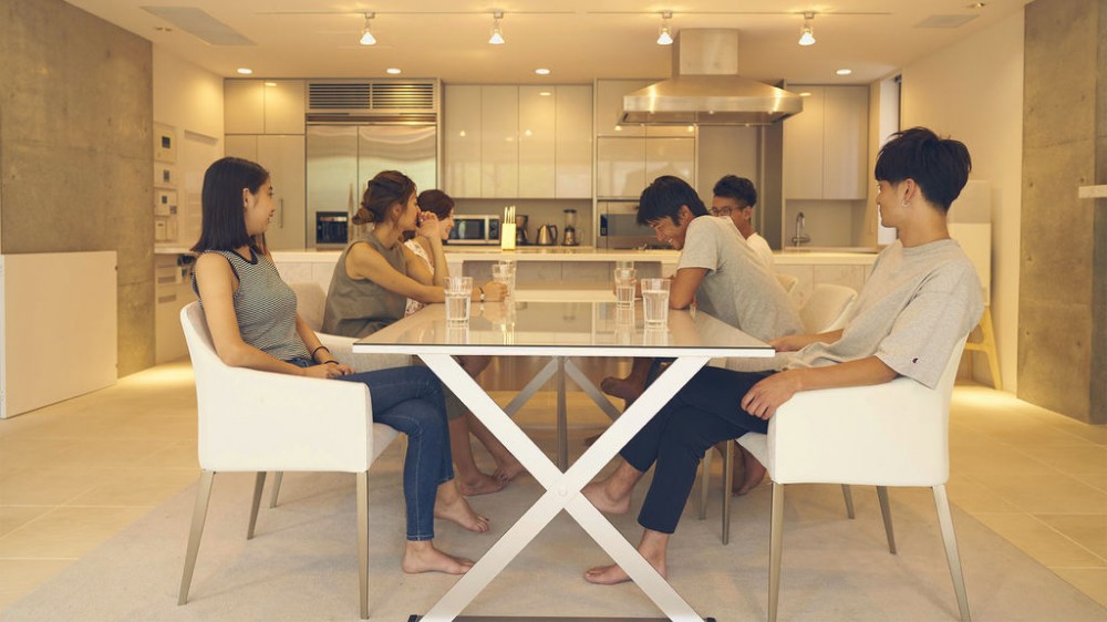 The roommates at the dining table in the Tokyo luxurious house. 