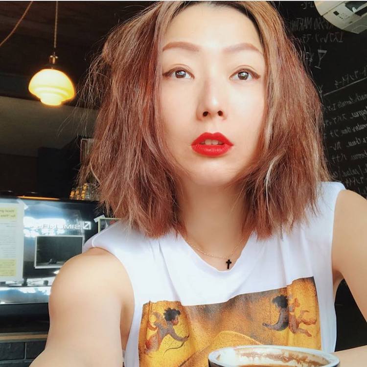 Sammi Cheng wearing the delicate Florence T mini cross