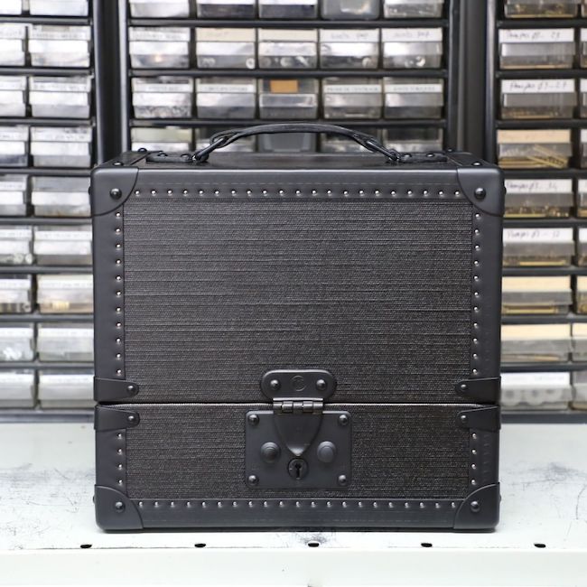 The new SS19 trunk features all-black leather handles, matte metallic draw bolts, and clasp.