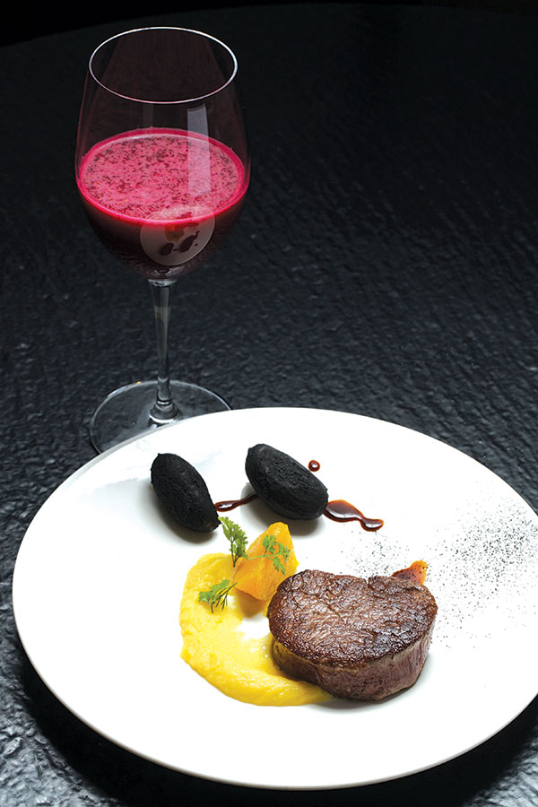 Beef served with black potatoes, paired with la vie en rose juice
