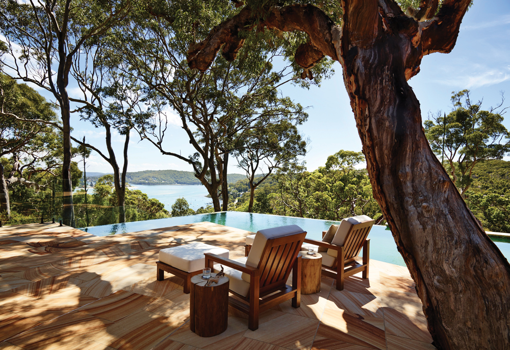 The tree-shaded pool area offers sweeping views of verdant nature and the Tasman Sea
