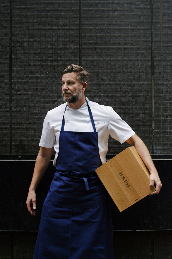 Chef Uwe Opocensky poses with a crate of Krug