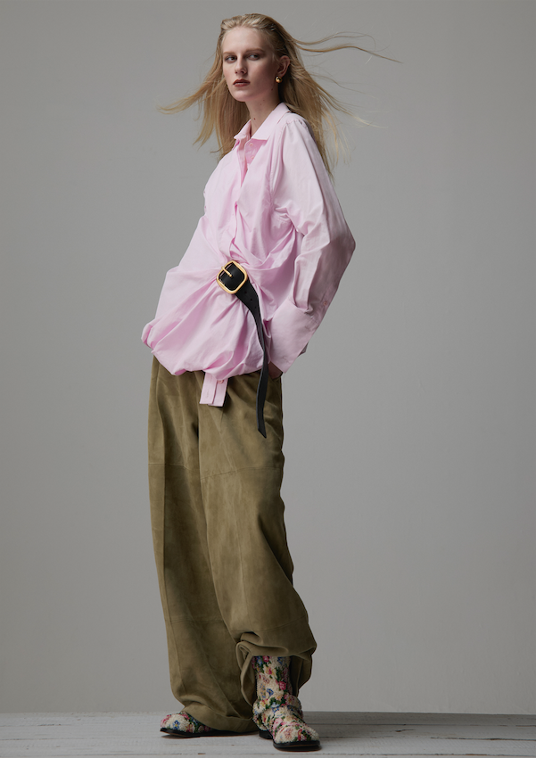 Pink shirt with belt detail, beige trousers and floral printed boots _ Loewe; Gold earrings _ Christian Diorr