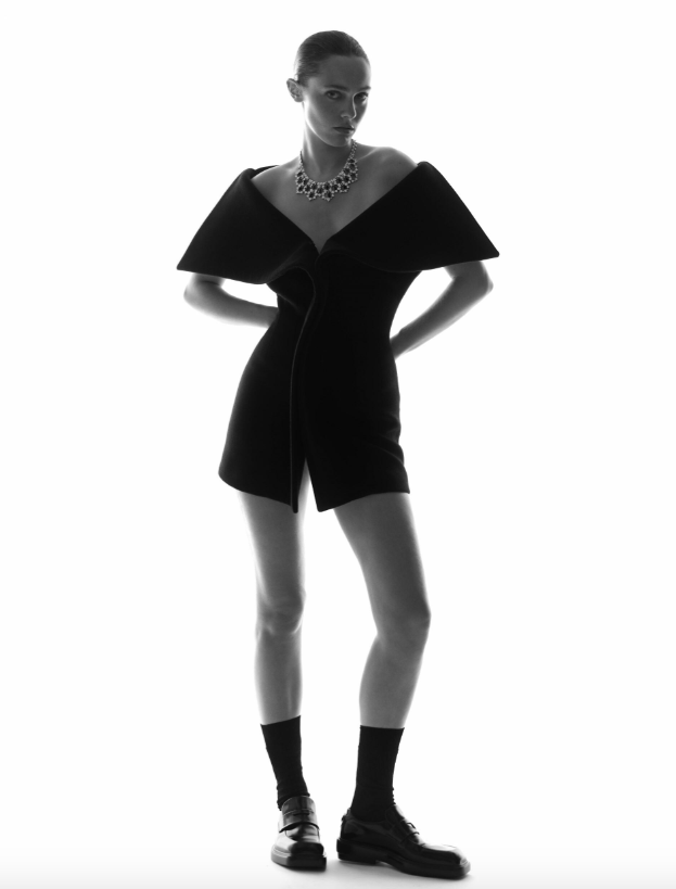 Necklace _ Buccellati; Black off-the-shoulder mini dress _ Ferragamo; Black loafers _ Prada