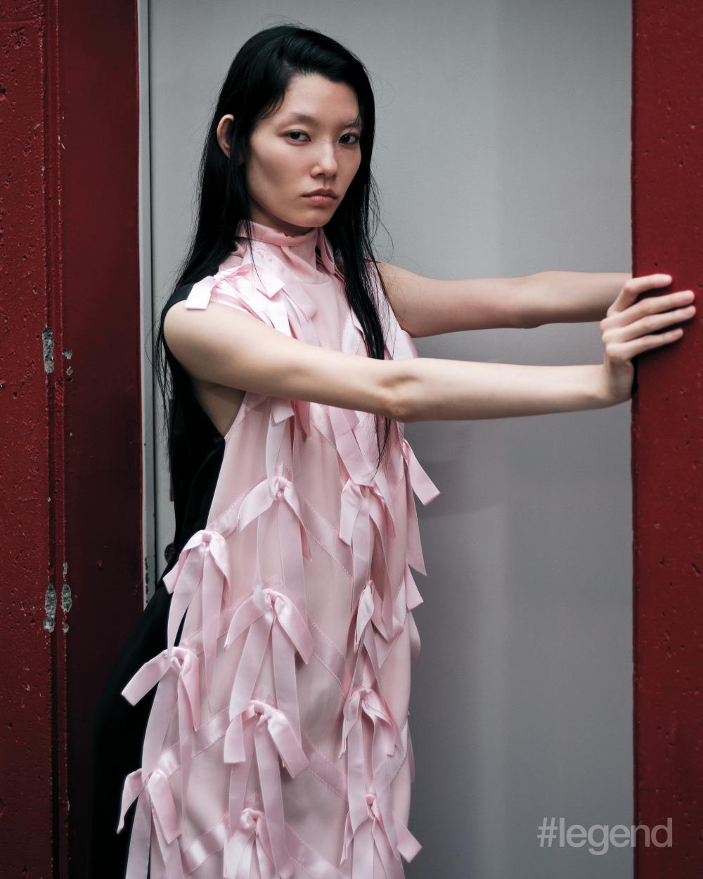 Pink bow dress and black shorts _ Prada; Black pumps _ Je la connais