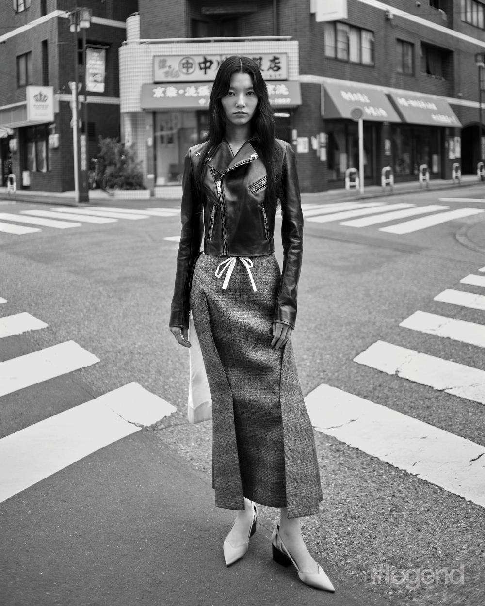 Black leather jacket, black and white deconstructed skirt, and white heels _ Prada