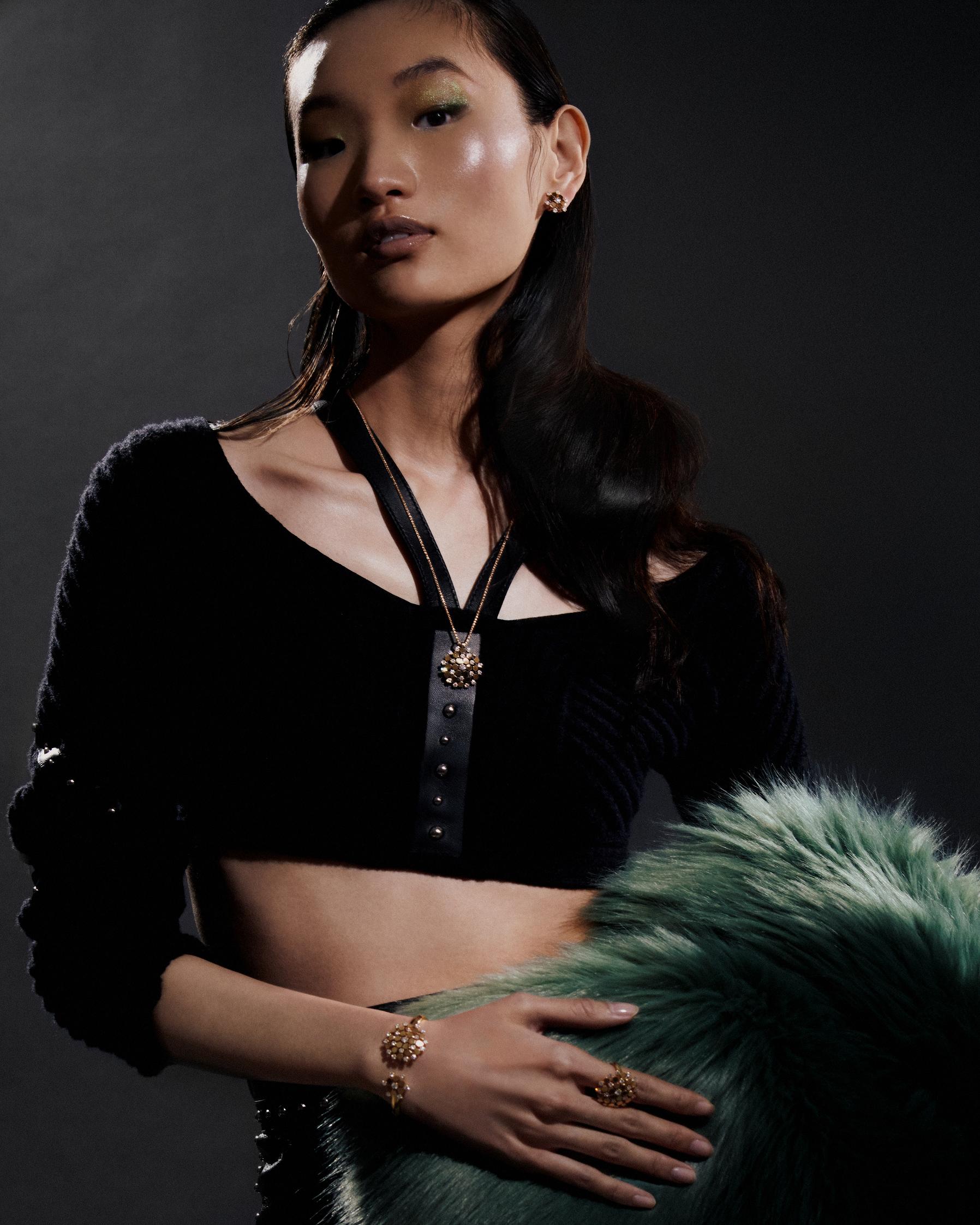 Bee My Love earrings, pendant, bracelet and ring in rose gold with diamonds _ Chaumet; Black knit top and leather skirt _ Hermès; Green faux fur coat _ Givenchy