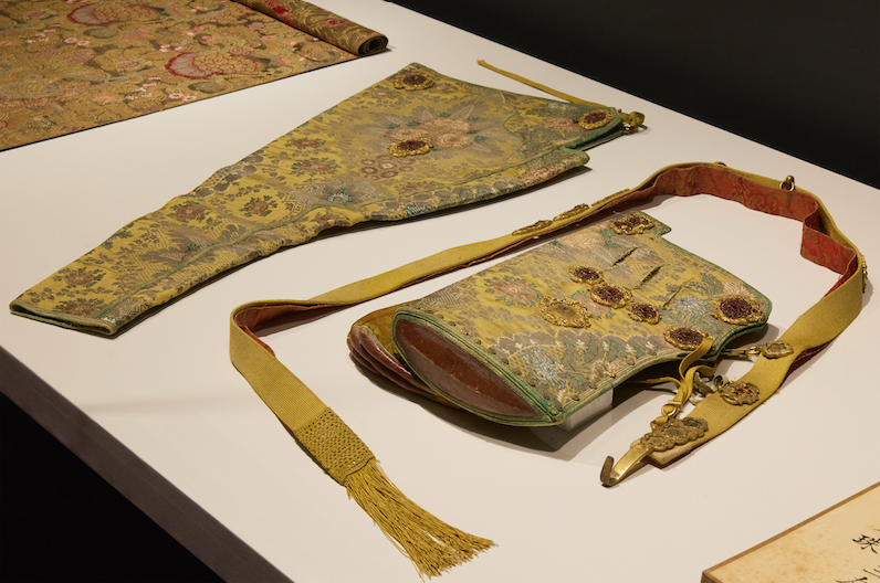 An embellished satin quiver and bow cases, also from the Qing dynasty, Qianlong period (1736-1795).