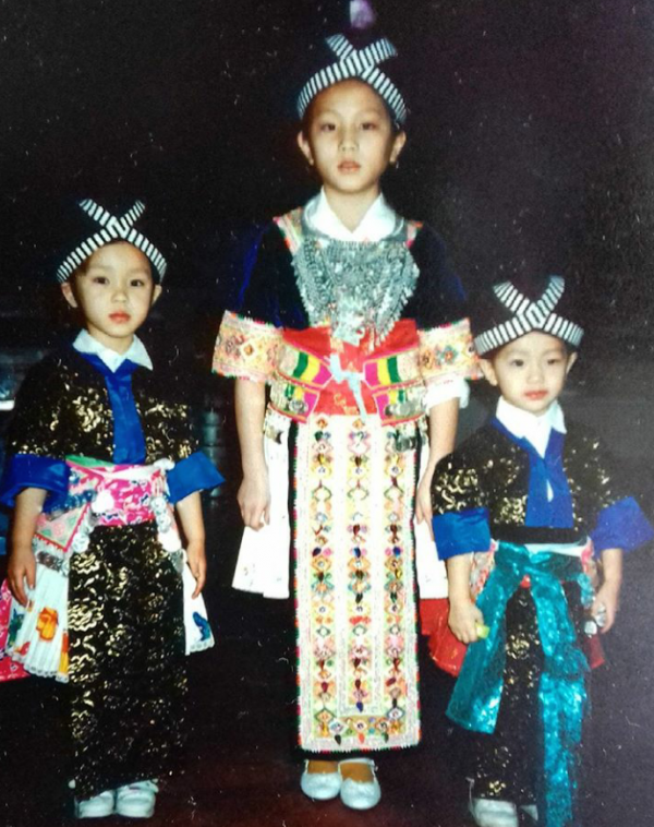 Thao and her sisters wearing traditional Hmong clothes