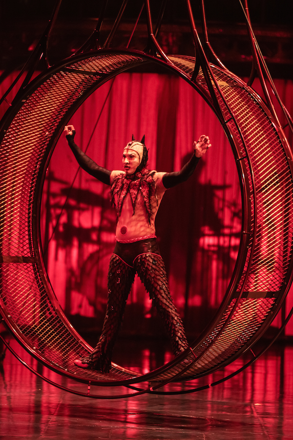A performer with a devil-inspired costume on the Wheel of Death 