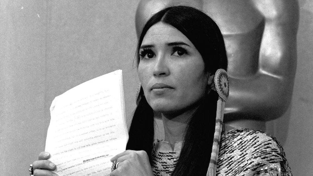 Native American activist Sacheen Littlefeather reads a letter on behalf of Marlon Brando on the stage of the 1973 Oscars