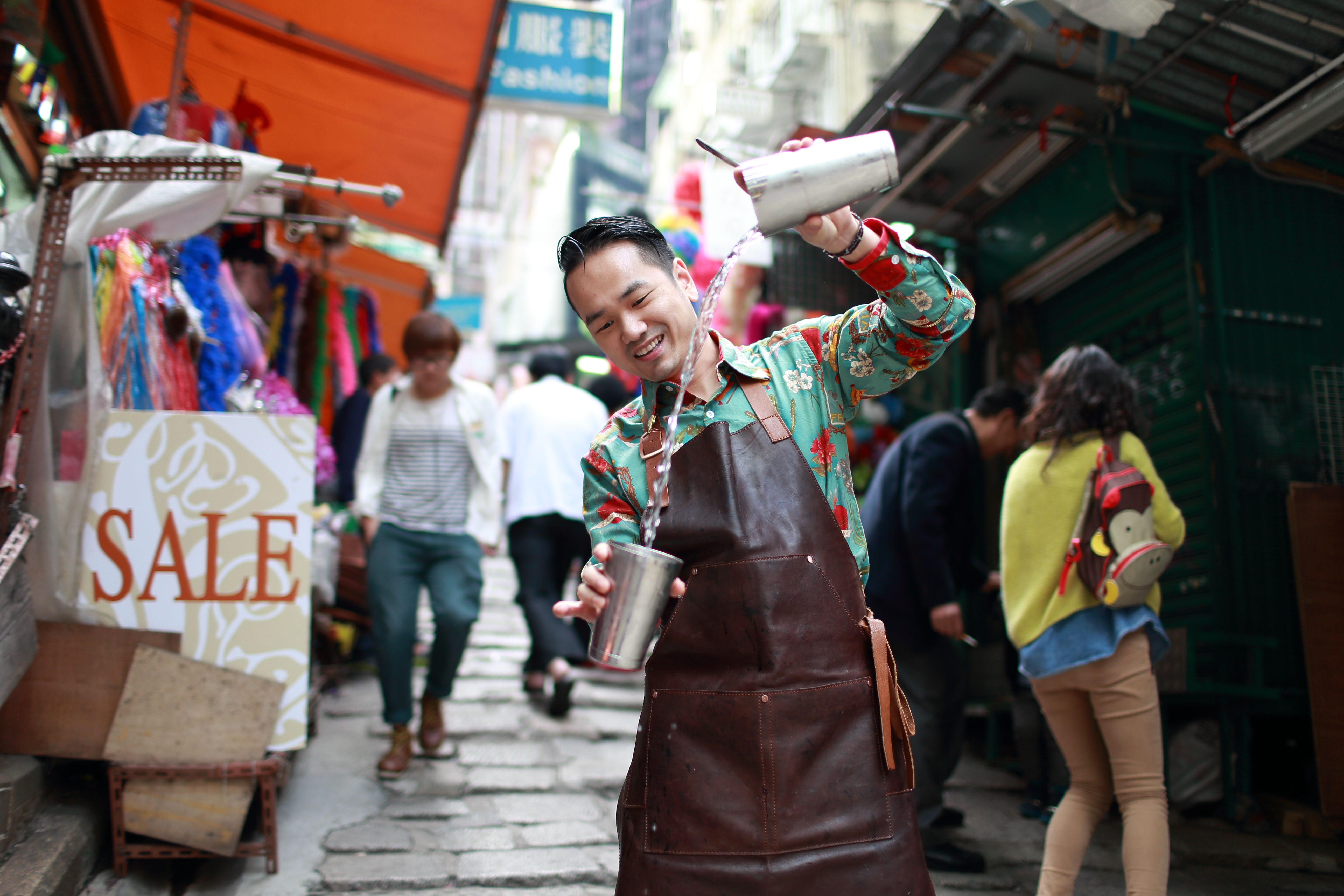 Antonio Lai mixes a drink.