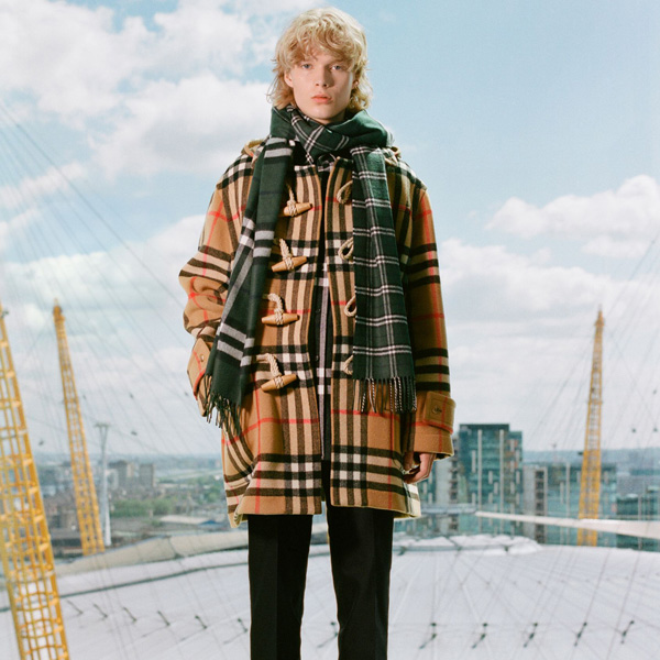 Model wears the Gosha x Burberry Check Oversized Duffle Coat, and the Gosha x Burberry Check Cashmere Double Scarf in Dark Forest Green