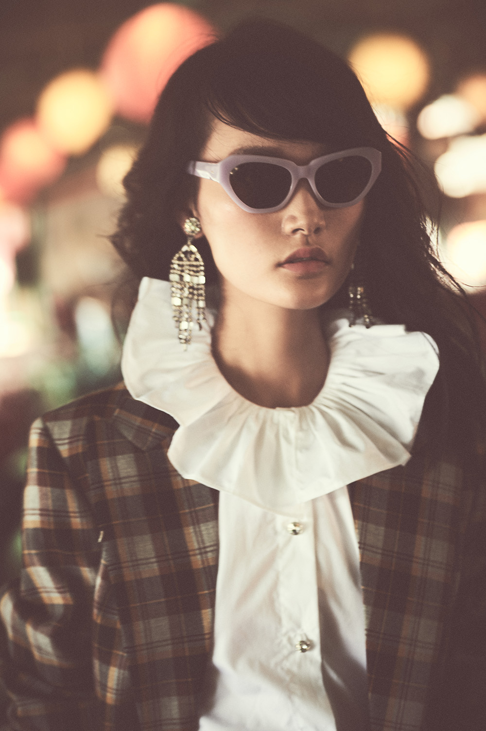 ￼Top and jacket by Miu Miu, earrings by Kenneth Jay Lane, sunglasses by Dries Van Noten, available at the DVN Boutique in Landmark