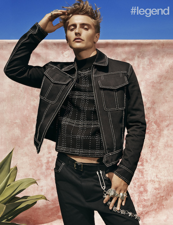 Black jacket, sweater and trousers with contrast stitching by Bottega Veneta; silver rings and wallet chain by Cody Sanderson