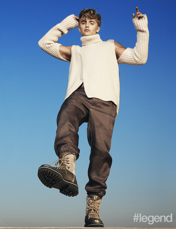 Cream cutout sweater, grey trousers and combat boots by Louis Vuitton