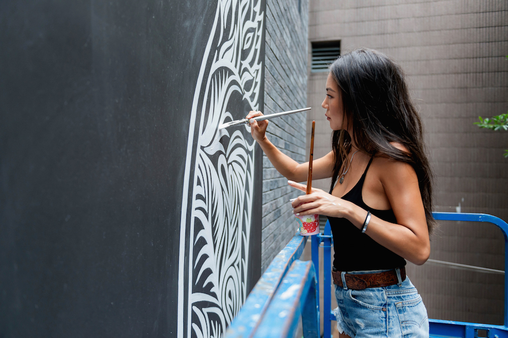 Mural artist Alana Tsui paints a mural at the entrance of Hong Kong's new urban-chic residential building The Mercury (photo: curtesy of the artist)