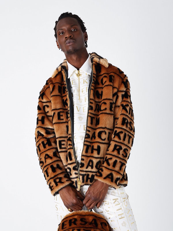 Kith X Versace camel fur coat covered in black branding graphics. From Kith.com.