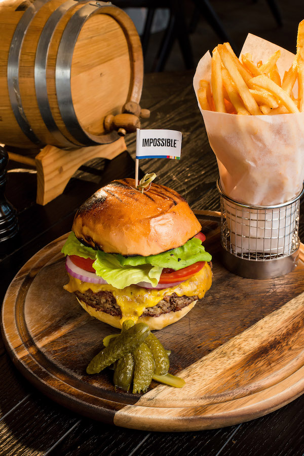 Impossible Burger with cheddar cheese, bacon and tartar sauce on a brioche bun from Bizou