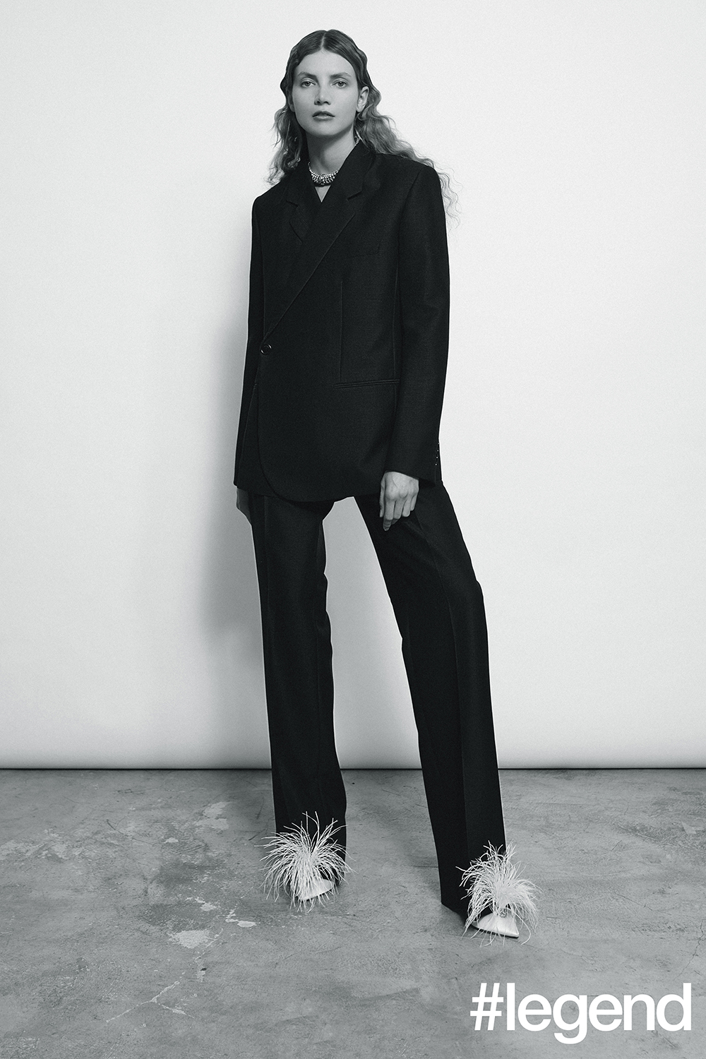 Black suit_Dior Homme; Rhinestone collar_Miu Miu; White pumps with plume_Jimmy Choo