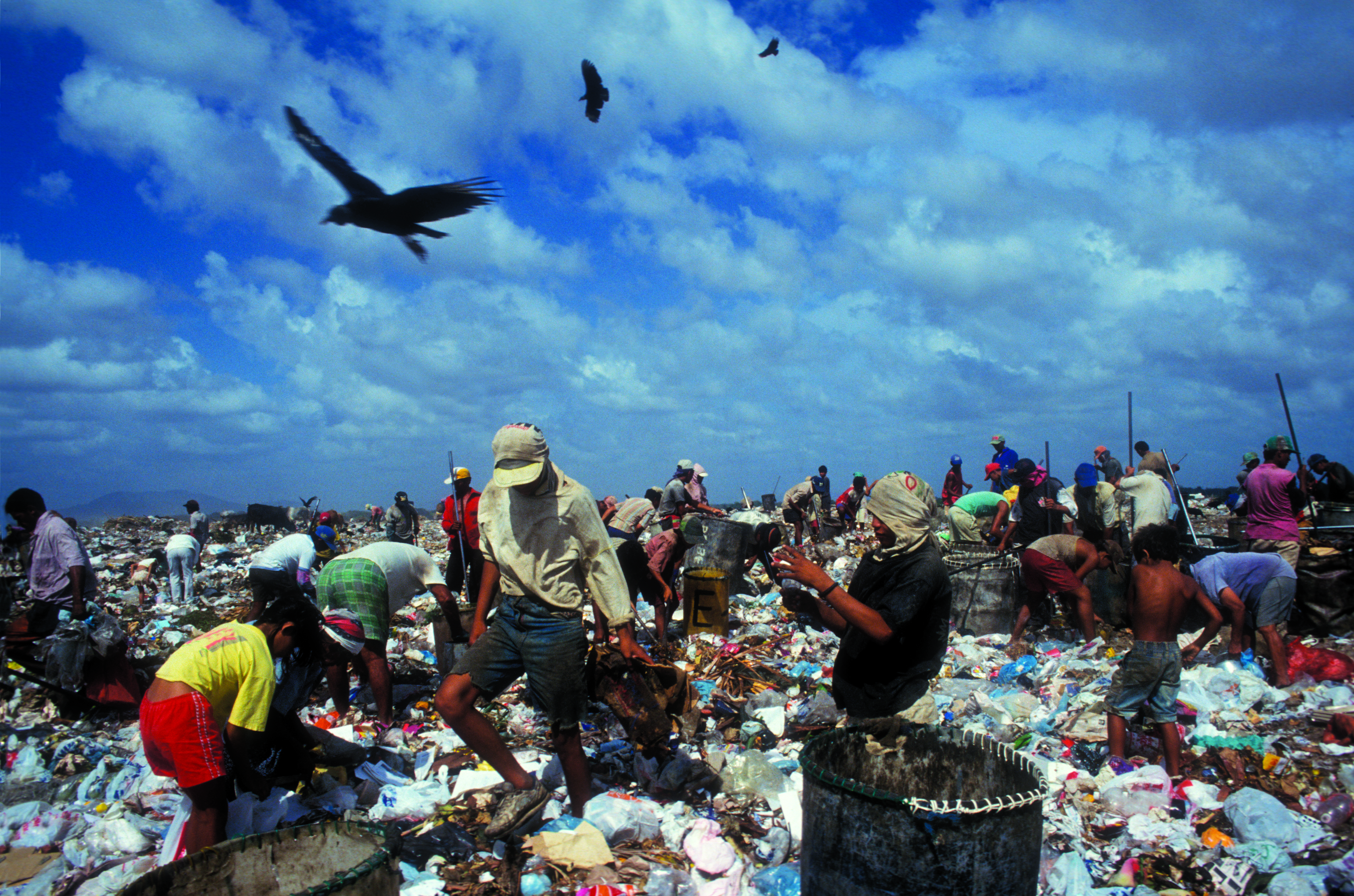 Workers going through unrecycled trash  in a landfill (photo: courtesy of National Geographic)
