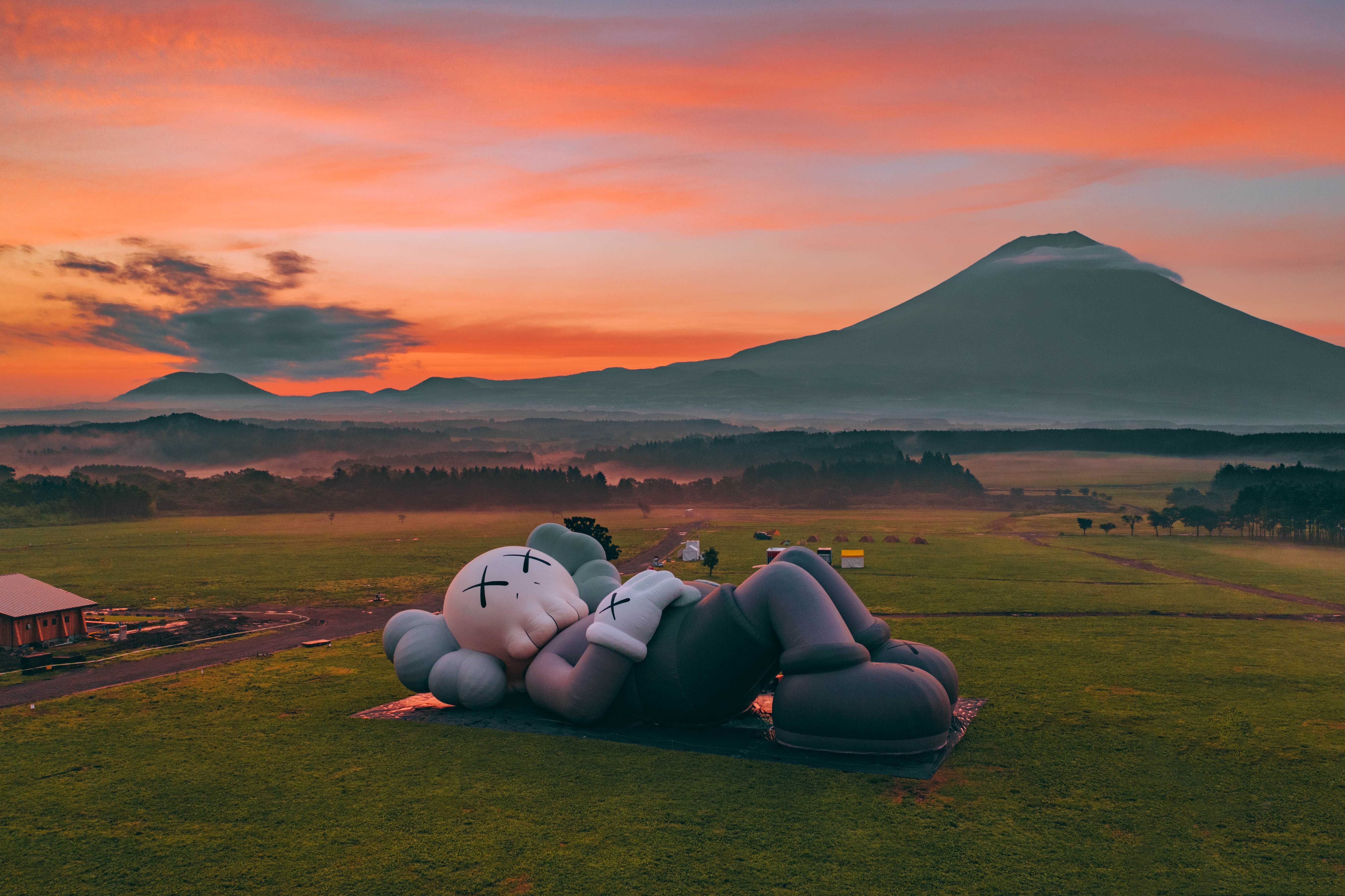 Aerial drone shot of the Kaws: Holiday sculptural piece at Mount Fuji