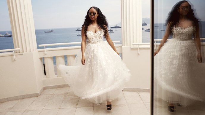 H.E.R in a stunning white ball-like gown with floral embroidery