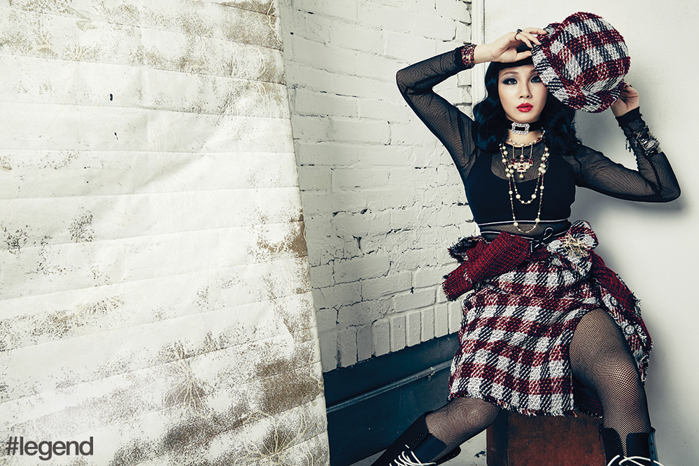 Necklaces, hat, skirt and jacket (tied around CL’s waist) by Chanel, choker and red ruby bracelets by Fallon Jewelry, bra top by Fenty x Puma, mesh unitard by Tripp NYC, cross bracelet and cuff by Lynn Ban and boots by Dr Martens