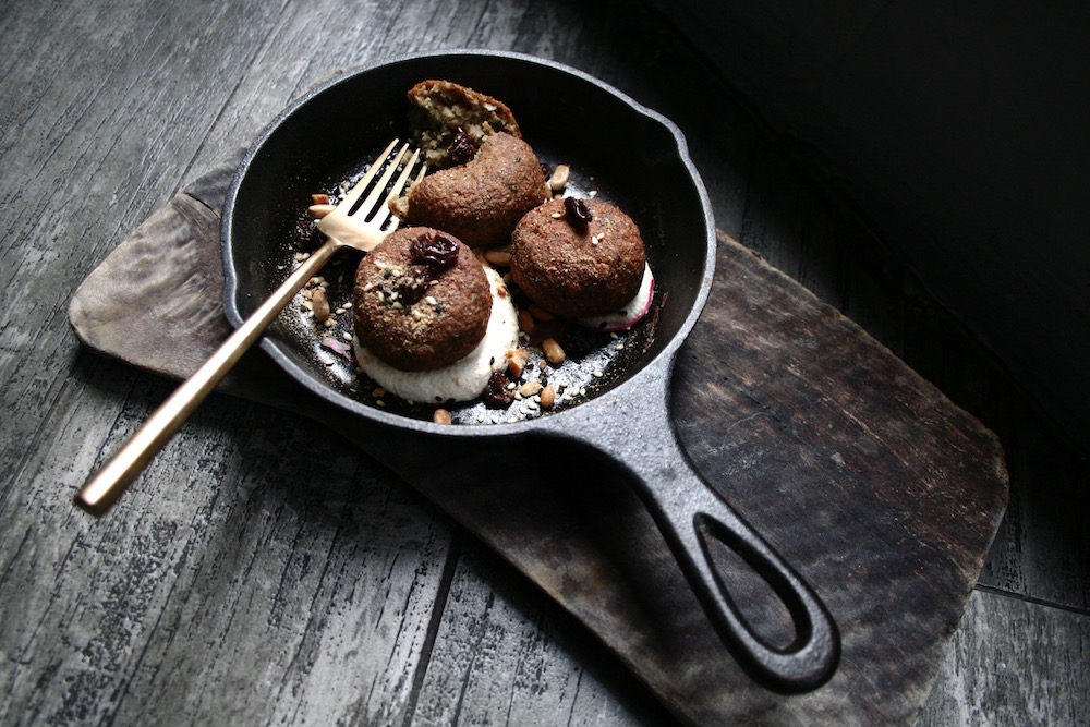 The lotus root kofta is served with a fresh tahini dressing made with toasted pine nuts, sweet spice plumped raisins and flax seed dukkah