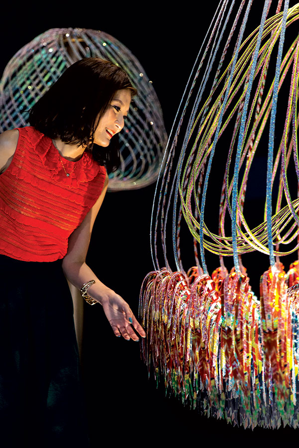 Elaine Ng admiring her creation, the kinetic crystal installation named Sundew