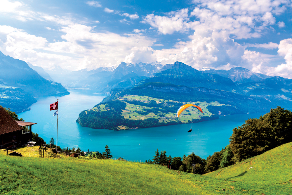Paragliding in Switzerland is popular because of its picturesque backdrops. Photo by Corbis