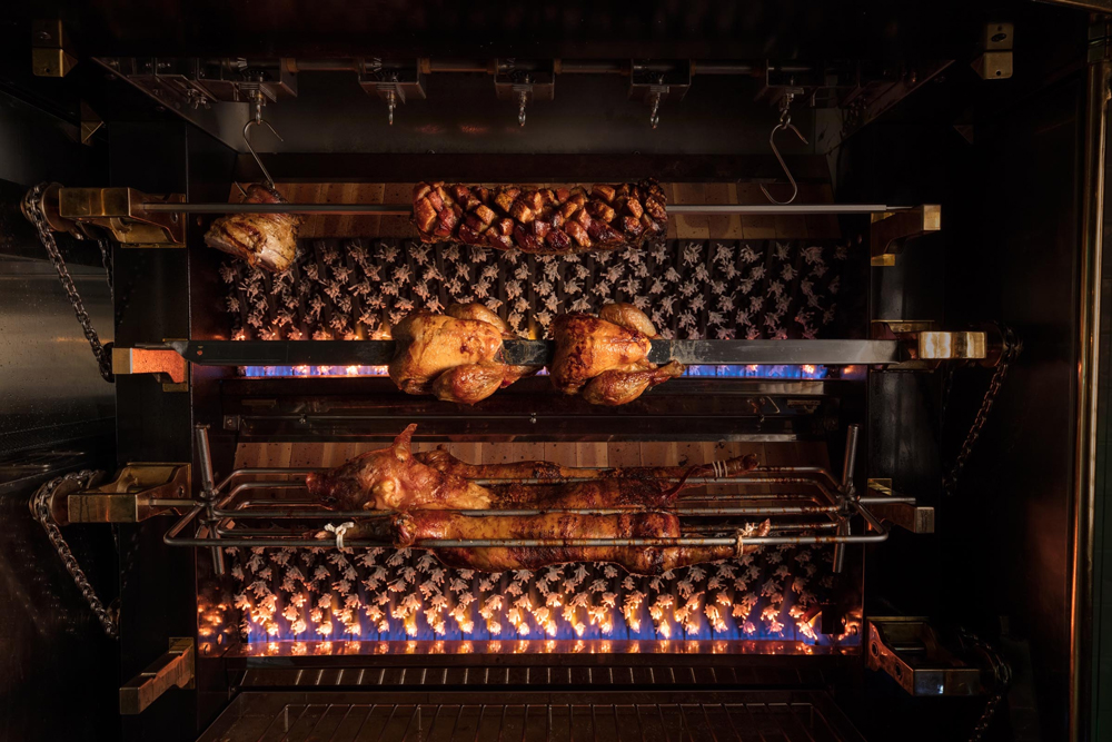 A variety of meats roasting on their in-house spit