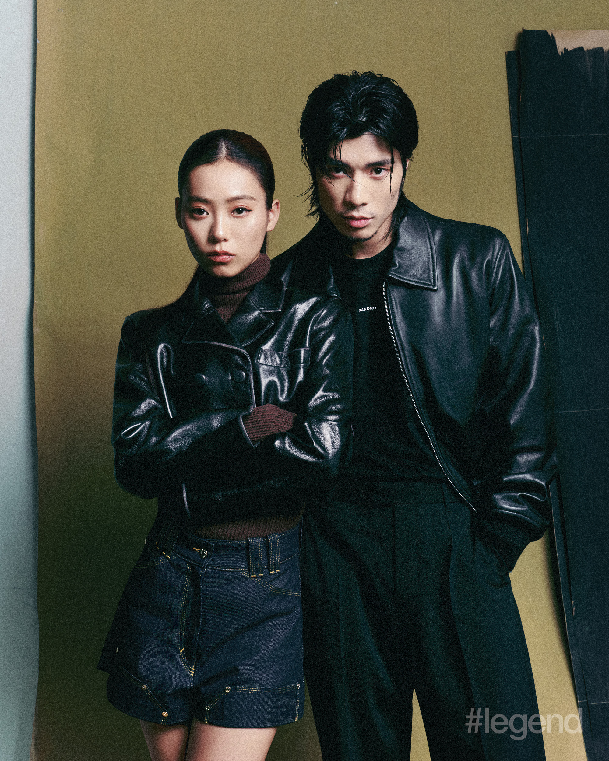 On Jace: Black leather crop jacket, burgundy turtleneck and indigo denim shorts _ Sandro. On Yan Ting: Black leather jacket, logo long-sleeve and trousers _ Sandro.