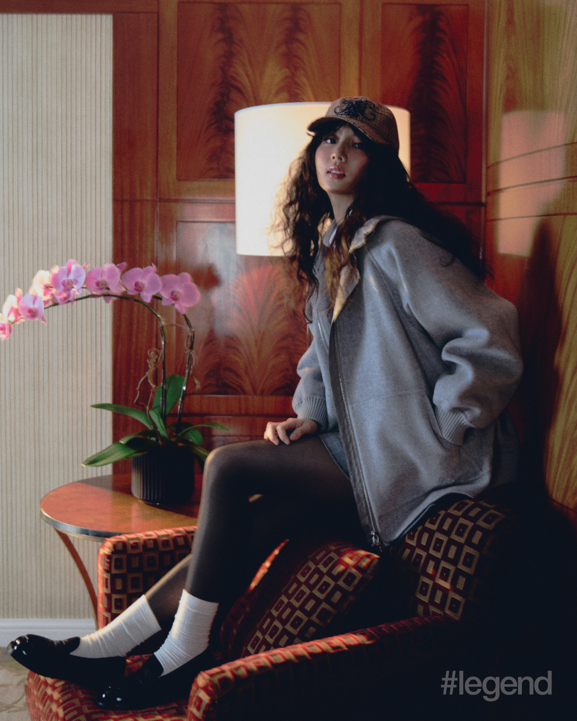 Grey hoodie, blazer and mini skirt, white shirt, emblem baseball cap and black loafers _ MAX&Co. (Stylist’s own tights and socks)