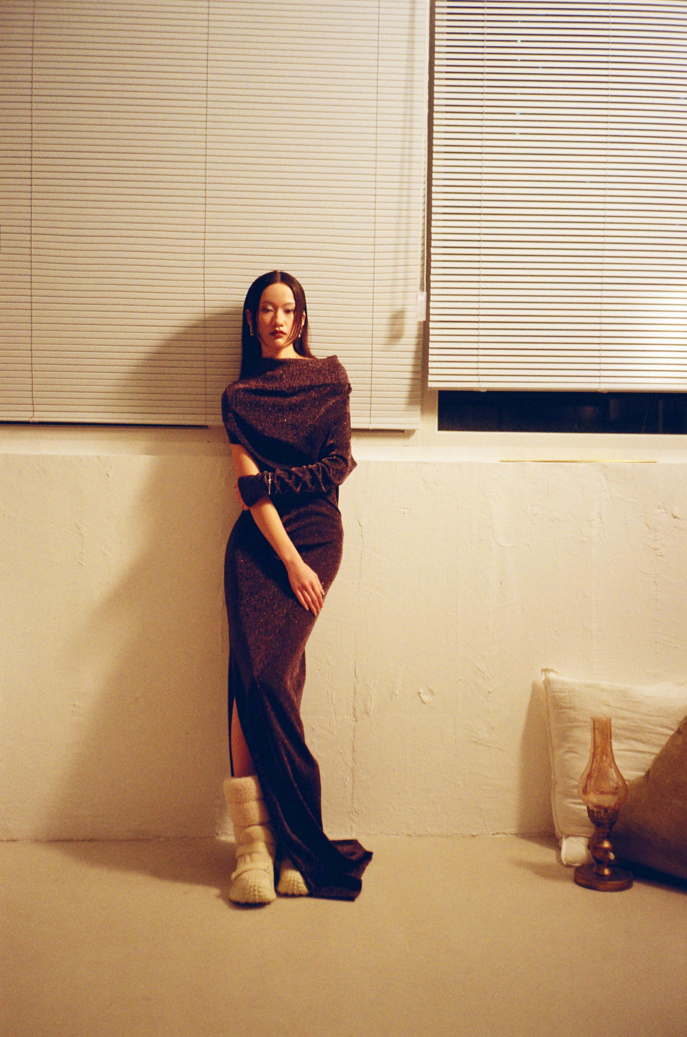 Black metallic knit dress _ Fendi; Earrings and bracelet _ Swarovski; White fur boots _ Moncler