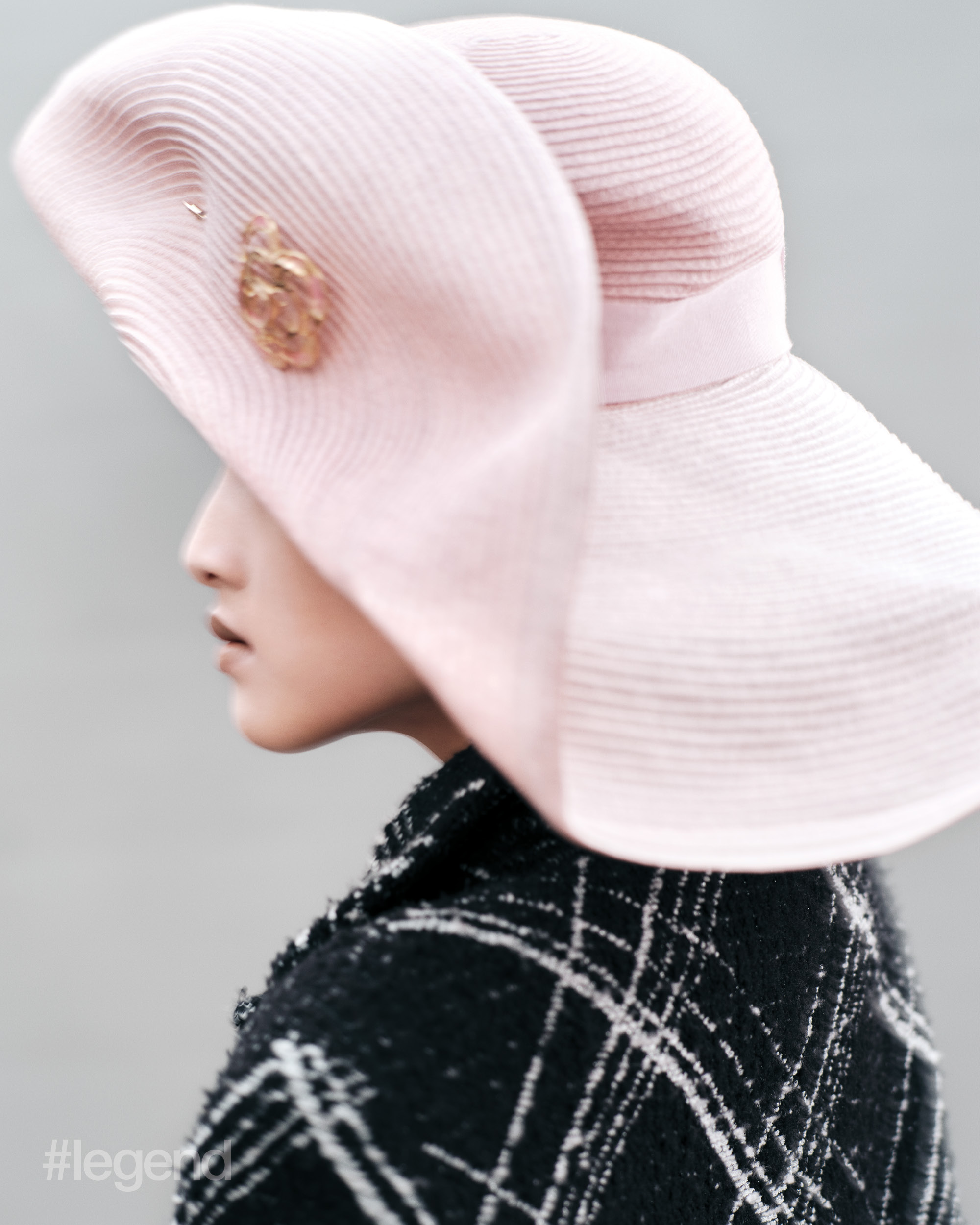 Black and white tweed coat, and pink hat _ Chanel; Black boots _ Gucci; (Stylist’s own skirt)