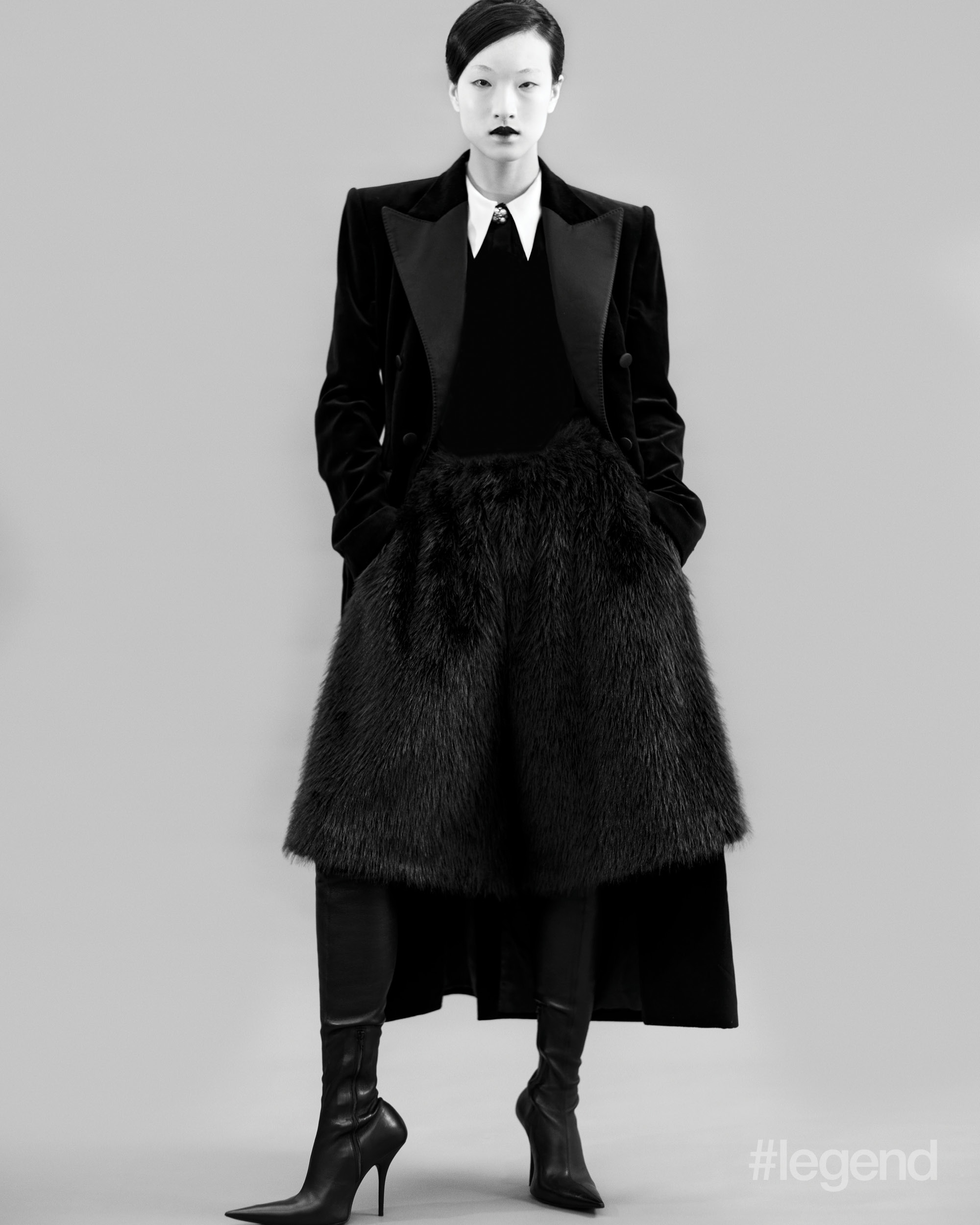 Black coat _ Dolce&Gabbana; White shirt _ Versace; Black shorts _ Simone Rocha; Black boots _ Balenciaga