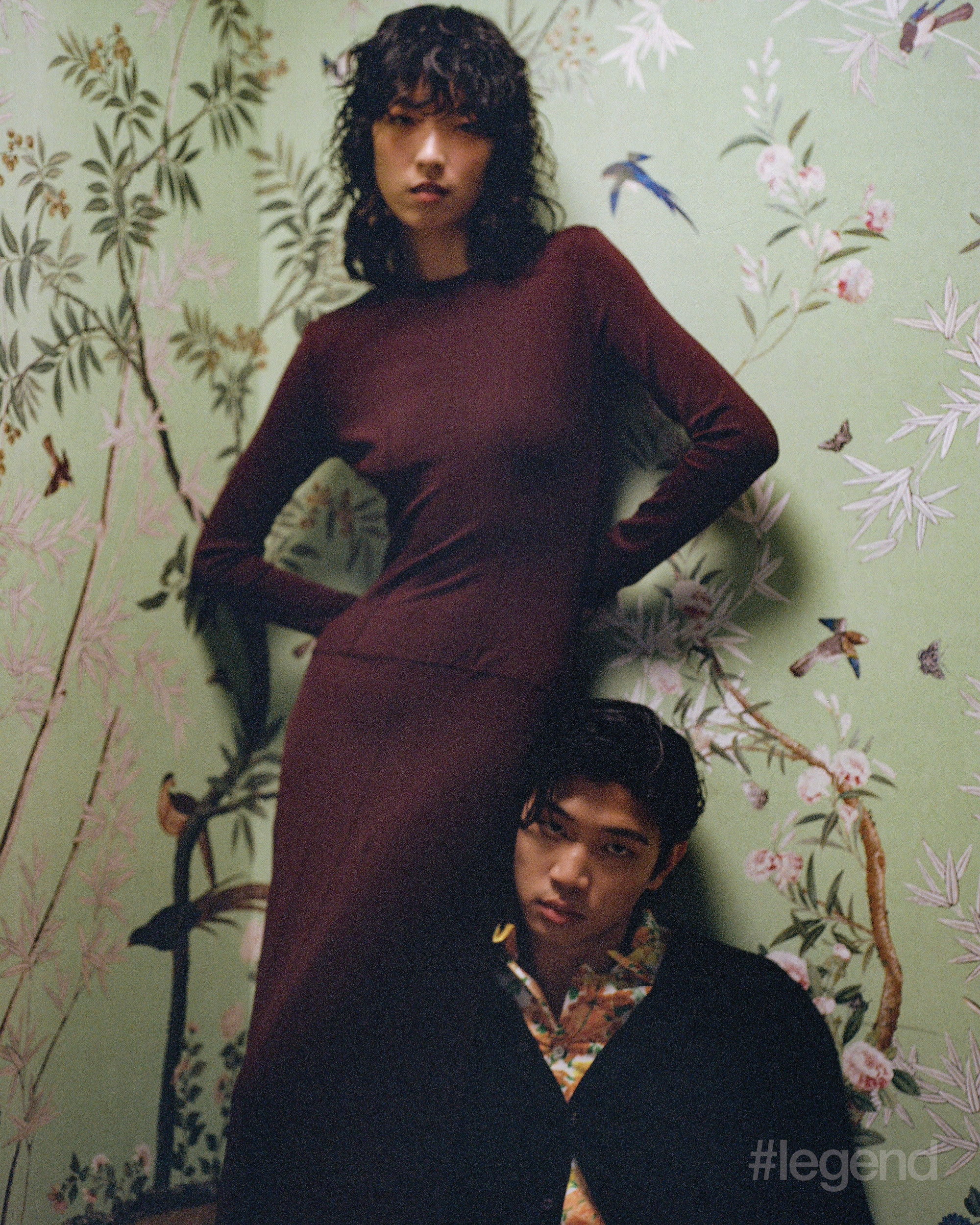 On Lu (left and opposite): Burgundy long-sleeve top and maxi skirt _ Vintage Alaïa from OnceStyle; Earrings _ Christian Lacroix from OnceStyle On Hayden (right): Black cardigan and multicolour shirt _ Prada