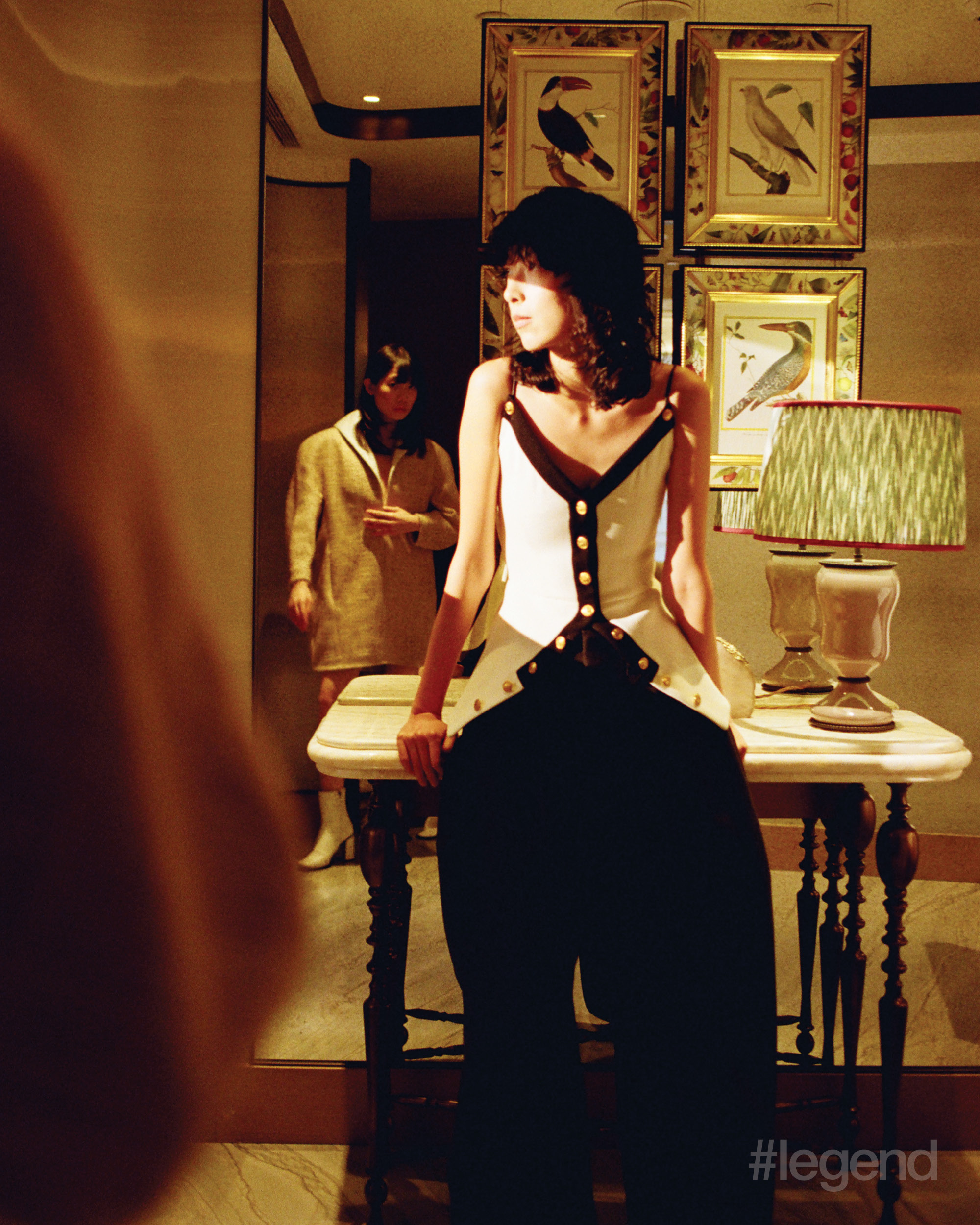 On Lu (foreground): White and black buttoned peplum top and black trousers _ Louis Vuitton