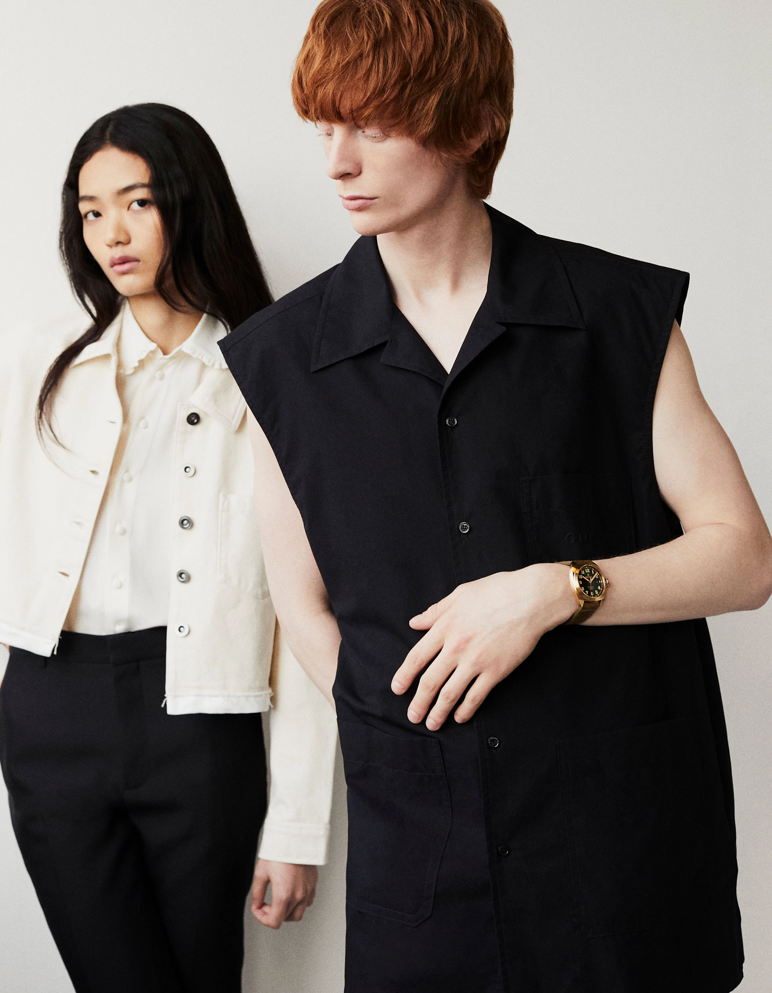 On Yuyu, White jacket _ Self-Portrait, White shirt _ Celine, Black trousers _ Loewe; On Mason, Terra Nova watch in bronze _ Bremont, Black sleeveless shirt and shorts _ Gucci