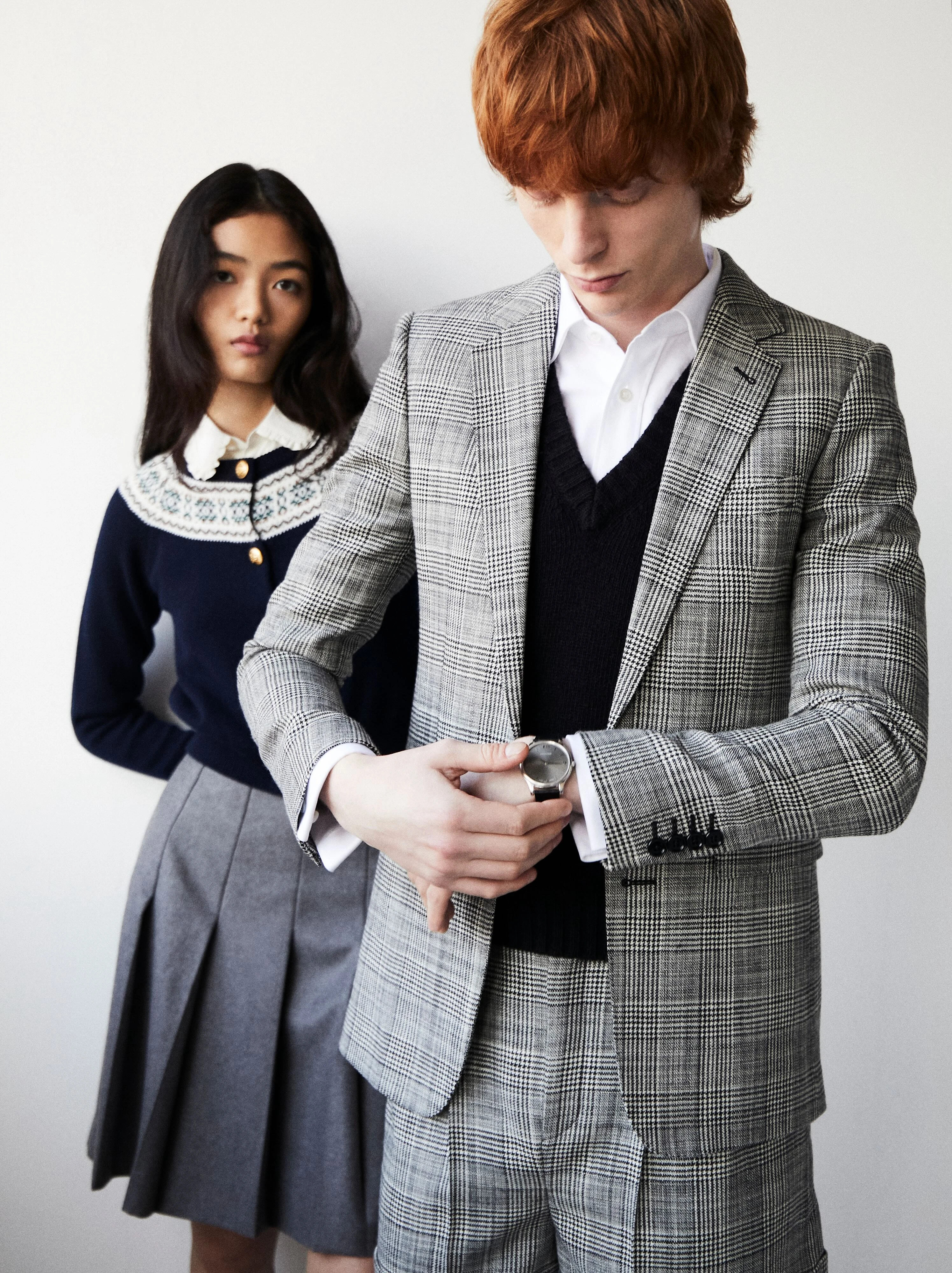 On Yuyu, White shirt, black cardigan and grey skirt _ Celine; On Mason L.U.C 6 Swiss watch _ Chopard Prince of Wales wool blazer and shorts, white shirt and black sweater _ Celine