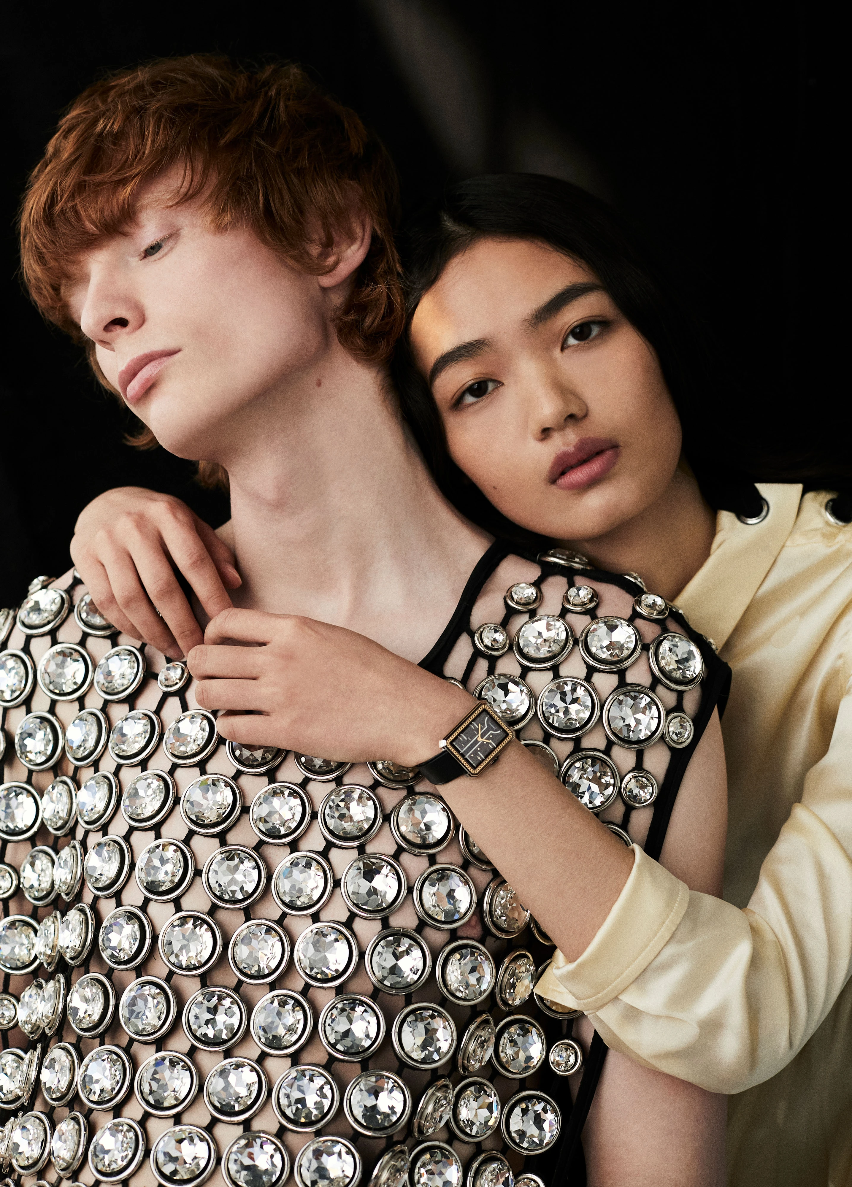 On Yuyu, BOY·FRIEND Couture watch in black-coated steel on black grosgain ribbon-pattern calfskin leather strap _ Chanel, Yellow dress _ Balenciaga; On Mason, Crystal embroidered top _ David Koma