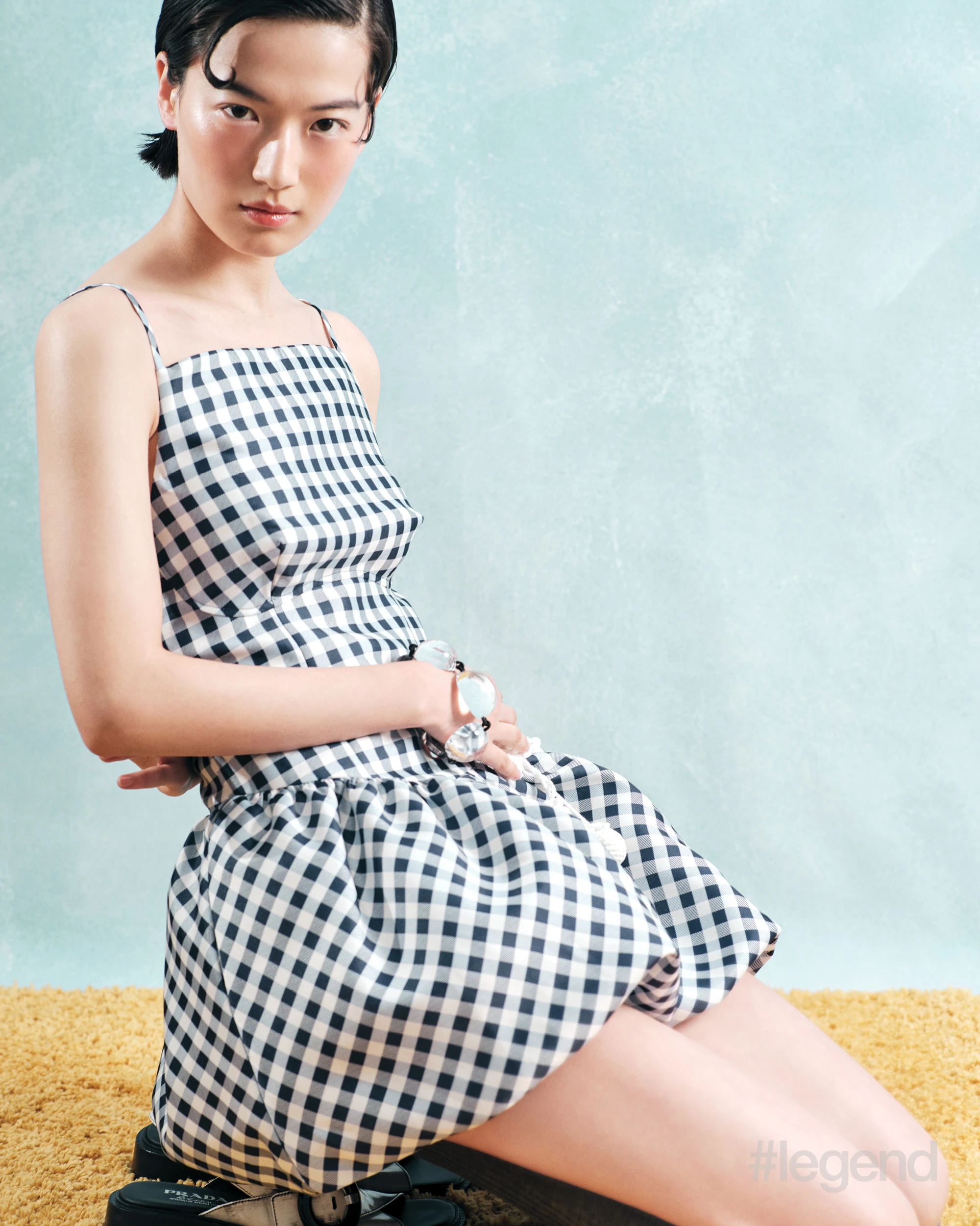 Blue gingham dress _ Self-Portrait; Grey socks _ Calzedonia; Black and white sandals _ Prada; Acrylic bracelet _ Monies