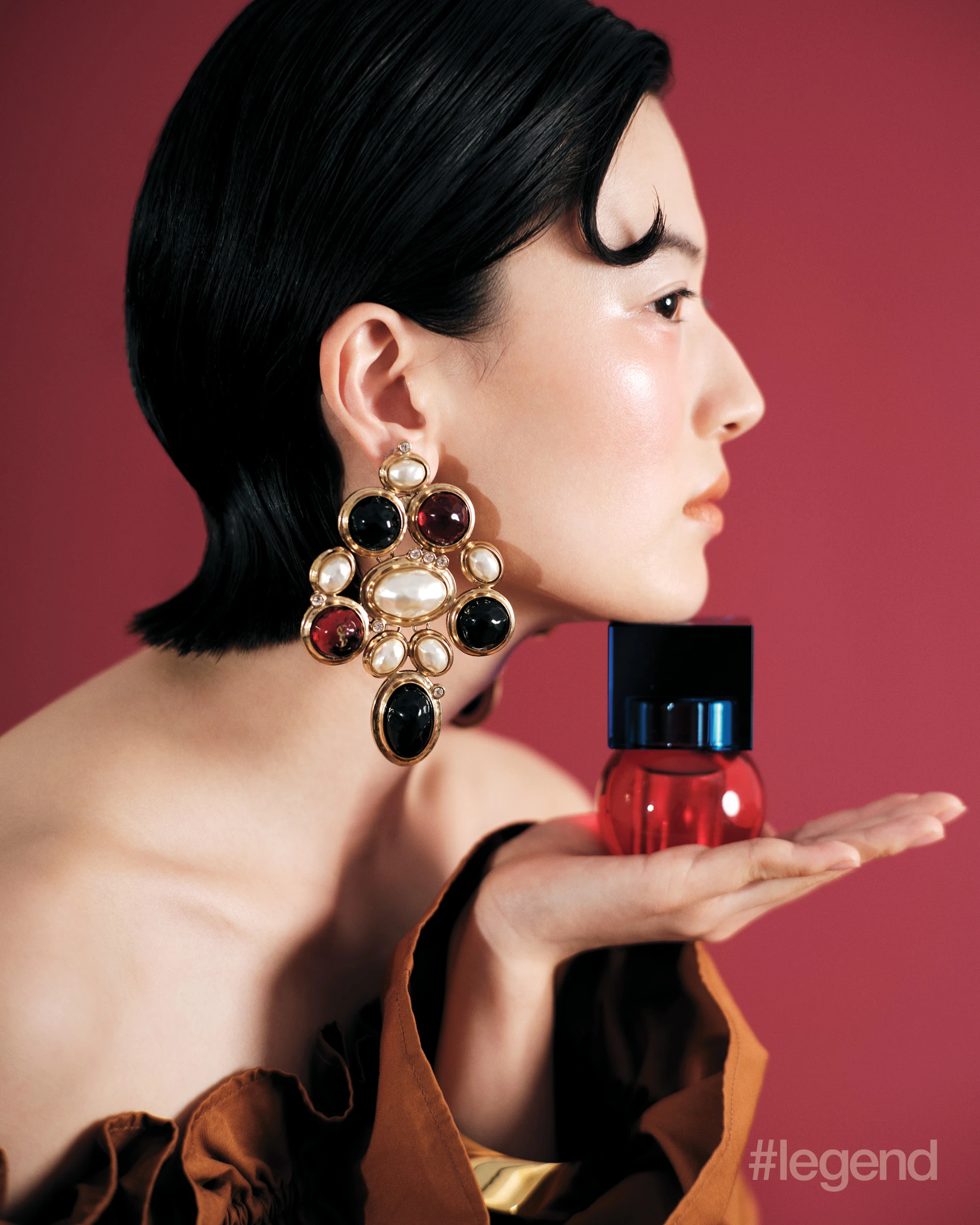 Brown off-the-shoulder dress, cabochon earrings and gold bangles _ Saint Laurent