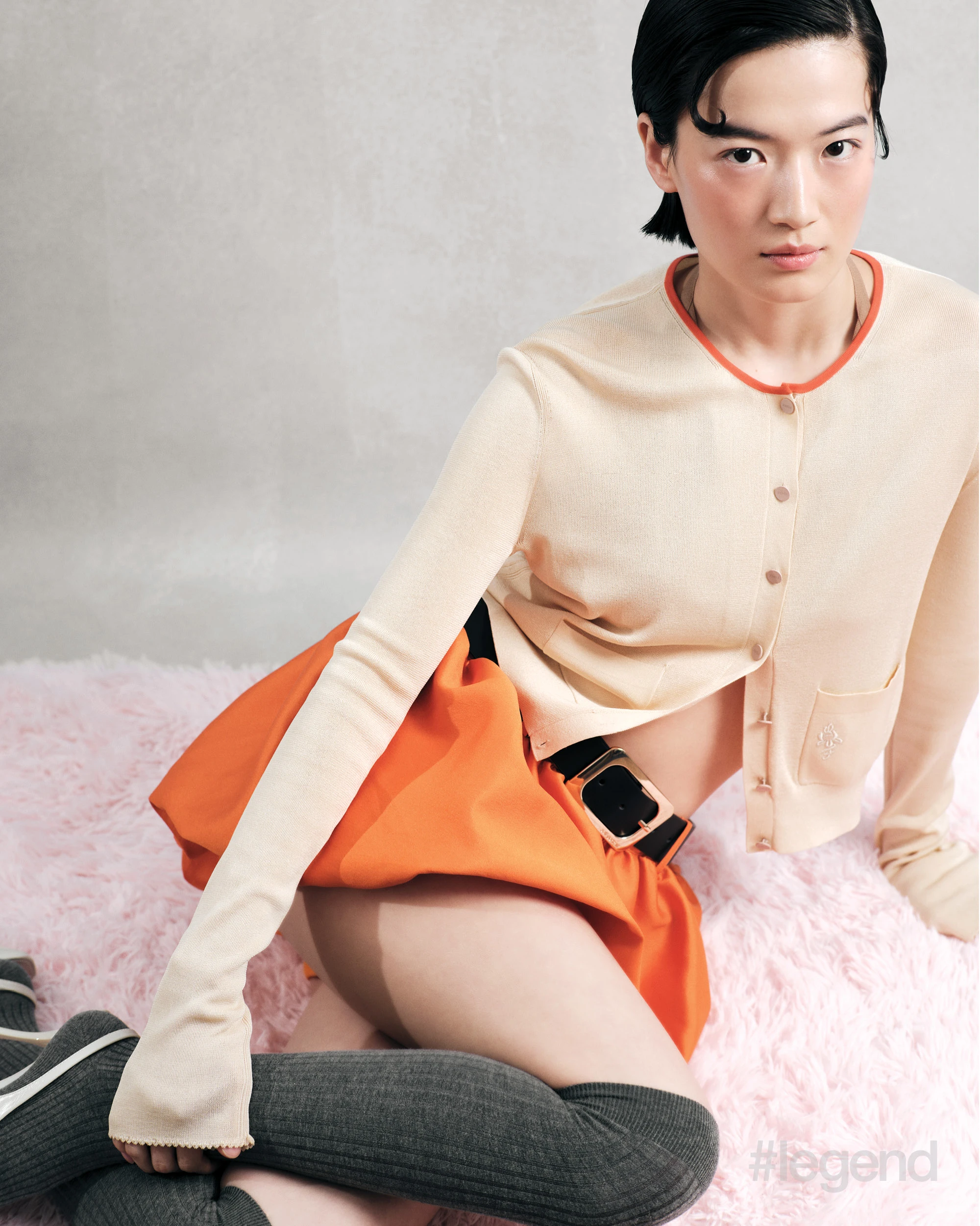 Beige bra _ Max Mara; Orange-trim beige cardigan _ Fendi; Orange skirt and black belt _ Self-Portrait; Grey socks _ Calzedonia; White slingbacks _ Khaite